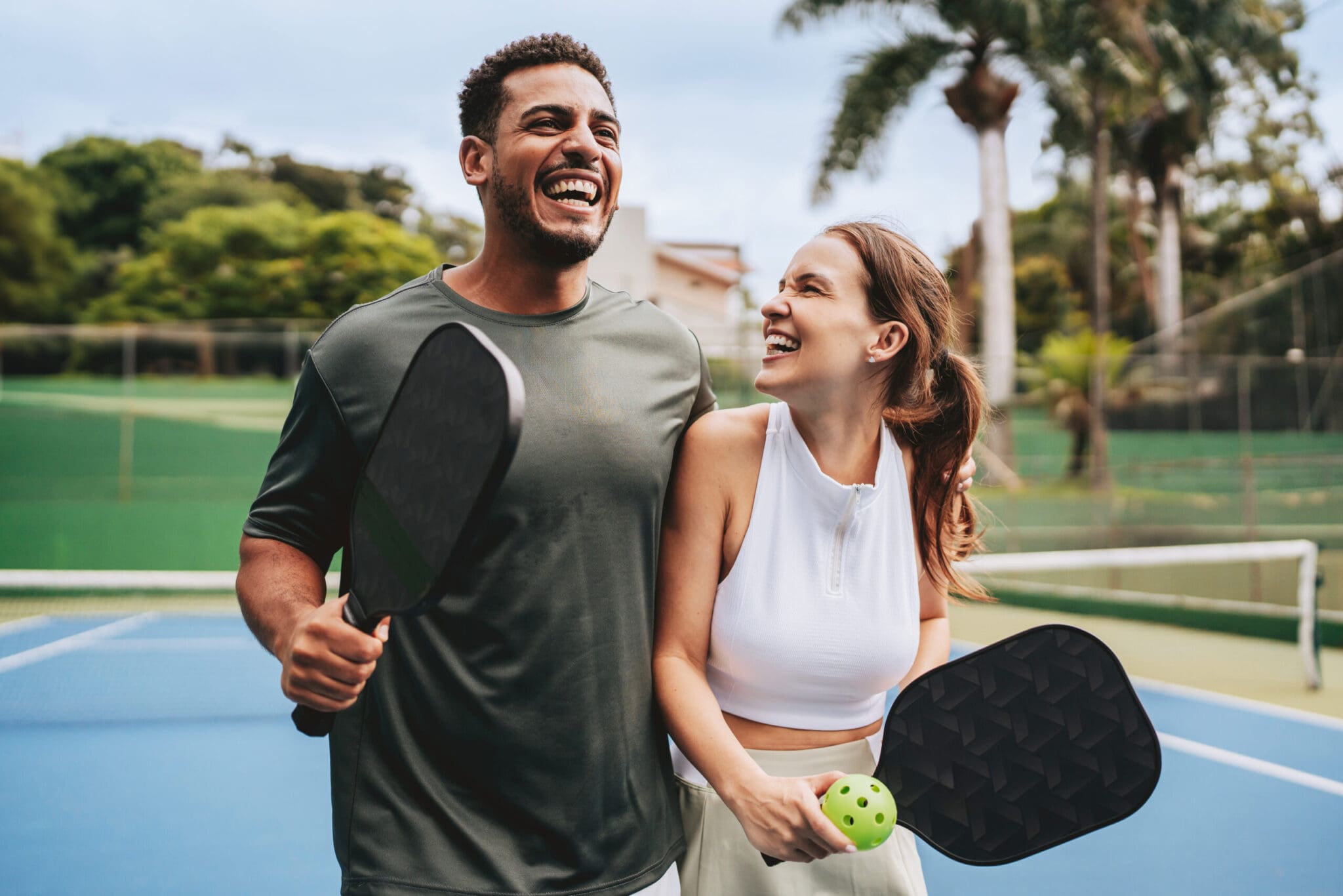 Couple playing pickleball celebrate point